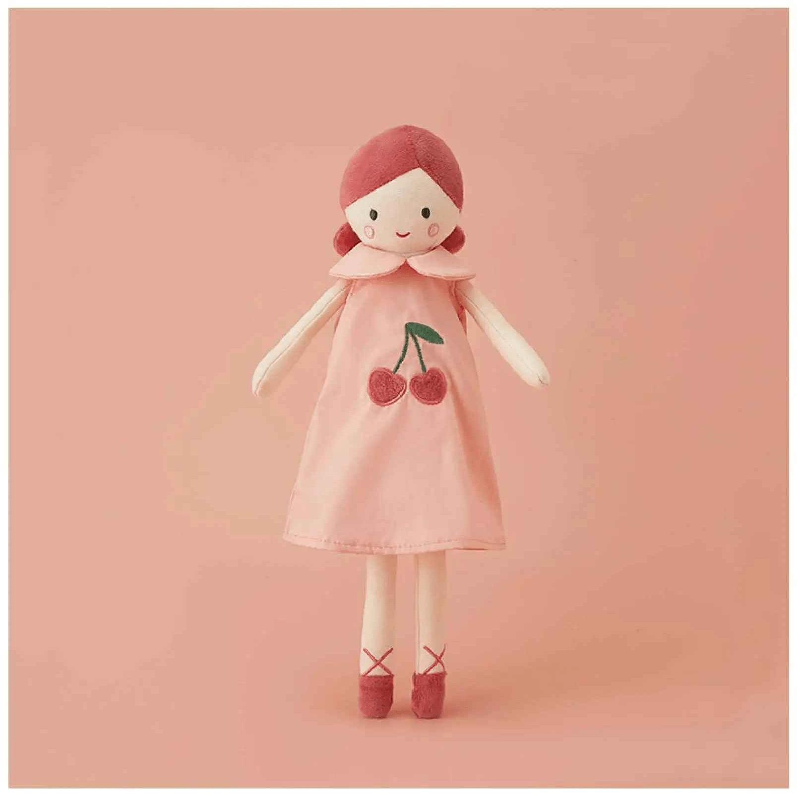 doudou poupée avec une robe rose avec des cerise