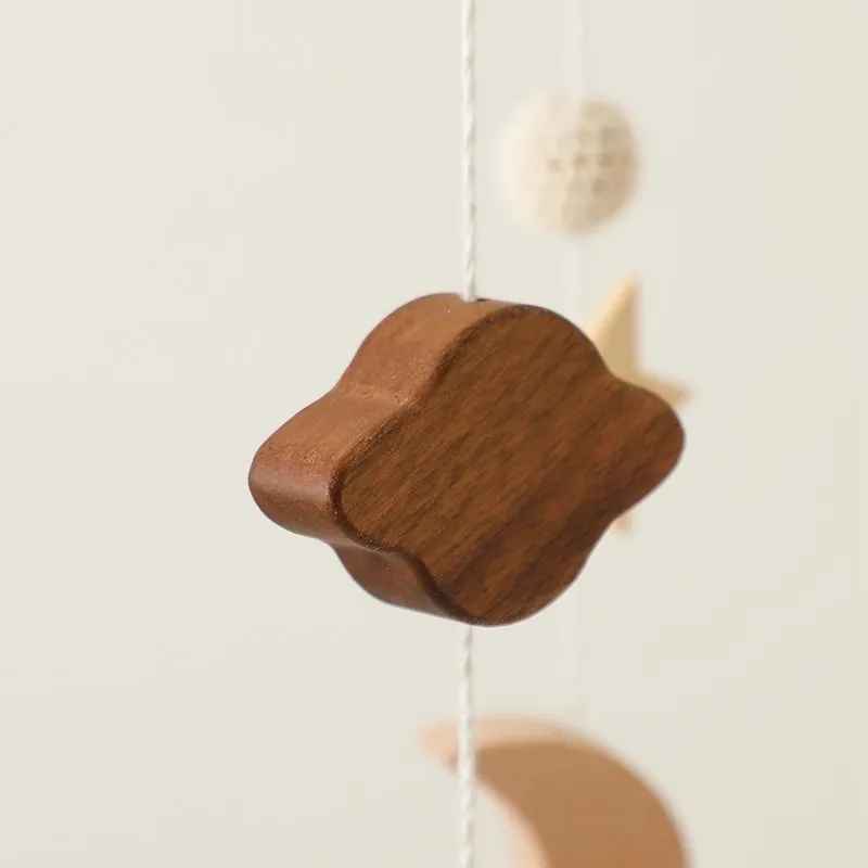 mobile bebe en gros plan le nuage en bois et une petite boule en arrière plan